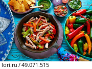 chicken fajitas in a pan with sauces chili and sides Mexican food. Стоковое фото, агентство Ingram Publishing / Фотобанк Лори