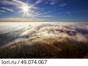 View on the sun over inversion from Jested, Jested-Kozakov ridge, Czech Republic. Стоковое фото, агентство Ingram Publishing / Фотобанк Лори