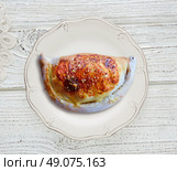 Pizza Calzone folded as a patty on a wooden board table. Стоковое фото, агентство Ingram Publishing / Фотобанк Лори