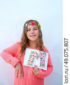 Blond kid girl painted M letter also fingers 
deaf alphabet. Стоковое фото, агентство Ingram Publishing / Фотобанк Лори