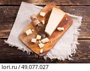 parmesan cheese on old wooden board. Стоковое фото, агентство Ingram Publishing / Фотобанк Лори