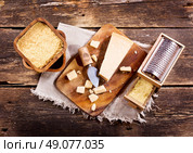 parmesan cheese on old wooden board. Стоковое фото, агентство Ingram Publishing / Фотобанк Лори