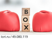 Boxing gloves and a boxing sign on a wooden table. Стоковое фото, агентство Ingram Publishing / Фотобанк Лори