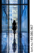 A womans silhouette walks towards a large window in a modern glass building, her reflection mirrored on the tiled floor. Стоковое AI-изображение, AI-художник Данила Большаков / Фотобанк Лори