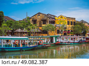 Vietnamese boats on the Thu Bon River in Hoi An Old town in Vietnam in summer. Vietnam, Hoi An - December 1, 2024. Редакционное фото, фотограф Корчагина Анастасия / Фотобанк Лори