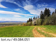 Spring green hills blooming. Valley behind the foothills in Ukraine. Стоковое фото, агентство Ingram Publishing / Фотобанк Лори