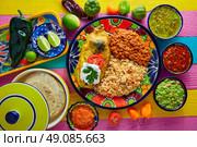 Chili relleno chili peppers filled with cheese in dish with with rice and frijoles beans. Стоковое фото, агентство Ingram Publishing / Фотобанк Лори