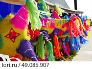 Mexican party pinatas decorated with fringed tissue colorful paper. Стоковое фото, агентство Ingram Publishing / Фотобанк Лори