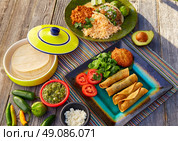 Mexican carnitas tacos with flautas from Mexico food ingredients. Стоковое фото, агентство Ingram Publishing / Фотобанк Лори