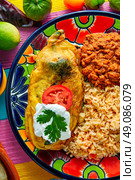 Chili relleno chili peppers filled with cheese in dish with with rice and frijoles beans. Стоковое фото, агентство Ingram Publishing / Фотобанк Лори