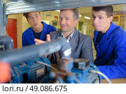 Teacher assessing students’ work, not impressed. Стоковое фото, агентство Ingram Publishing / Фотобанк Лори