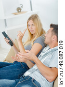 Couple arguing over remote control. Стоковое фото, агентство Ingram Publishing / Фотобанк Лори