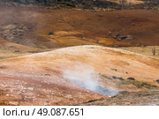 Geothermal activity in icelandic nature with steam coming up from the ground. Стоковое фото, агентство Ingram Publishing / Фотобанк Лори