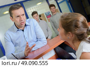 Man at reception desk getting angry. Стоковое фото, агентство Ingram Publishing / Фотобанк Лори