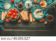 Unadulterated italian strawberry tiramisu cooking ingredients on dark rustic kitchen table, top view, place for text. Italian food concept, border. Стоковое фото, агентство Ingram Publishing / Фотобанк Лори