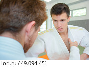 Two young men in martial art combat. Стоковое фото, агентство Ingram Publishing / Фотобанк Лори