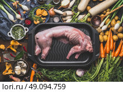 Raw uncooked whole rabbit and various cooking ingredients for stew or ragout. Rabbit stew preparation with forest mushrooms and  vegetables of autumn season on dark rustic background, top view. Стоковое фото, агентство Ingram Publishing / Фотобанк Лори