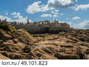 View of the fortress city of Saint-Malo on the English Channel and the ocean floor exposed at low tide on a sunny summer day, Brittany, France. Стоковое фото, фотограф Ula Ulachka / Фотобанк Лори