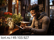 The Digital Chronicles: focused afriacn american man sits in wheelchair at sleek table, engrossed in using tablet to document and gather knowledge. Стоковое AI-изображение, AI-художник Данила Большаков / Фотобанк Лори