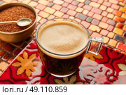 Coffee glass cup with cream on tiles red brown golden table. Стоковое фото, агентство Ingram Publishing / Фотобанк Лори