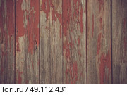 Red paint pealing off old wooden planks. Стоковое фото, агентство Ingram Publishing / Фотобанк Лори