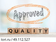 Approved quality sign on a desk in a bright room. Стоковое фото, агентство Ingram Publishing / Фотобанк Лори