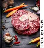 Veal shank slices meat and ingredients for Osso Buco cooking, close up. Стоковое фото, агентство Ingram Publishing / Фотобанк Лори