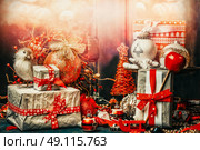 Pretty Christmas card with festive gifts, bird,decoration and balls . Holiday bokeh lighting, retro styled. Стоковое фото, агентство Ingram Publishing / Фотобанк Лори