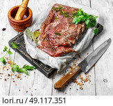 meat prepared for jerky. raw meat in spicy spices and seasonings on the kitchen board. Стоковое фото, агентство Ingram Publishing / Фотобанк Лори