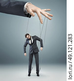 conceptual photo of a boss pulling the strings. Стоковое фото, агентство Ingram Publishing / Фотобанк Лори