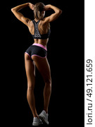Young fitness girl isolated on black. Стоковое фото, агентство Ingram Publishing / Фотобанк Лори