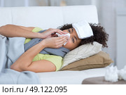 a beautiful ill woman siting on the sofa. Стоковое фото, агентство Ingram Publishing / Фотобанк Лори