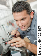 Repairing a car part. Стоковое фото, агентство Ingram Publishing / Фотобанк Лори