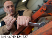 mechanic man using a wrench. Стоковое фото, агентство Ingram Publishing / Фотобанк Лори