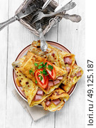 Pancakes for Shrove Tuesday. Tasty pancakes stuffed with meat and mushrooms on the plate. Стоковое фото, агентство Ingram Publishing / Фотобанк Лори