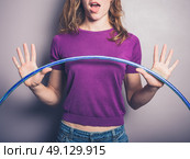 A happy young woman is holding a hula hoop. Стоковое фото, агентство Ingram Publishing / Фотобанк Лори