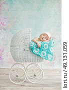 Cute child sleeping in the wicker pram. Стоковое фото, агентство Ingram Publishing / Фотобанк Лори