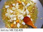 seafood paella from spain recipe second step ad cuttlefish to onion and garlic. Стоковое фото, агентство Ingram Publishing / Фотобанк Лори