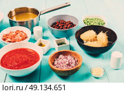 Red and Yellow Capsicum, Onion, Bacon, Vegetable Stock, Ketchup, Beans and Peas And Vermicelli Pasta Food Ingredients For Minestrone Soup Recipe. Стоковое фото, агентство Ingram Publishing / Фотобанк Лори