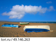 Valencia La Malvarrosa beach arenas beached boats in Spain. Стоковое фото, агентство Ingram Publishing / Фотобанк Лори