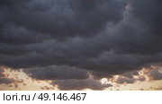 Dramatic storm clouds forming during sunset, ideal for weather, climate change, natural forces, or autumn seasonal themes and moods. Стоковое AI-видео, аниматор Башкирова Анна / Фотобанк Лори