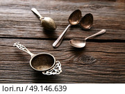 Vintage retro tea Strainers silver brass on wooden background. Стоковое фото, агентство Ingram Publishing / Фотобанк Лори