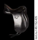Black leather premium dressage saddle isolated at black background. Стоковое фото, агентство Ingram Publishing / Фотобанк Лори