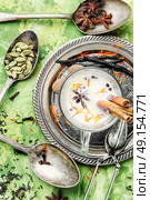 Masala tea ingredients. glass of Indian tonic tea with milk and spicy spices. Стоковое фото, агентство Ingram Publishing / Фотобанк Лори