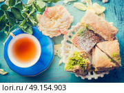 Afternoon tea time with cup of tea and  Homemade Phyllo Pastry cakes, top view. Стоковое фото, агентство Ingram Publishing / Фотобанк Лори