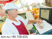 Butcher weighing some meat. Стоковое фото, агентство Ingram Publishing / Фотобанк Лори