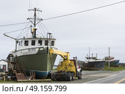 Crane by fishing trawler at harbor, Marie Joseph, Nova Scotia, Canada. Стоковое фото, агентство Ingram Publishing / Фотобанк Лори