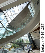 Museum Tower lobby with spiral glass staircase in Tel Aviv. Редакционное фото, фотограф Irina Opachevsky / Фотобанк Лори