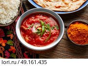 Chicken Tikka Masala indian recipe food on wooden table. Стоковое фото, агентство Ingram Publishing / Фотобанк Лори