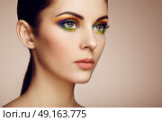 Portrait of beautiful young woman with rainbow make-up. Girl summer. Long eyelashes, vivid colorful eyeshadows. Multicolored. Стоковое фото, агентство Ingram Publishing / Фотобанк Лори
